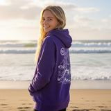 Purple hoodie with white artwork featuring a dog surfing on an oyster in Cape Cod located in the front of the Beachcomber in Wellfleet, MA. 